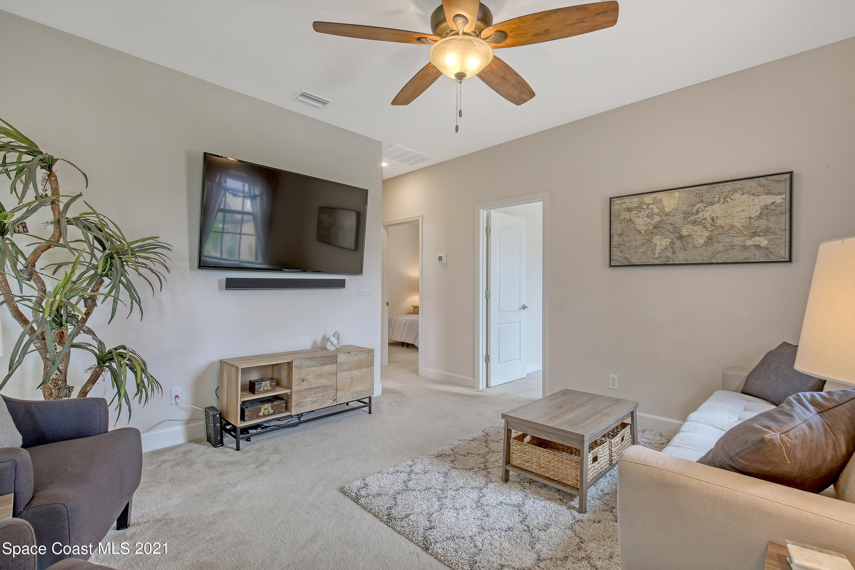 1380 Talon Way Melbourne, FL 32934 - Photo 22 of 59 a living room with furniture and a flat screen tv