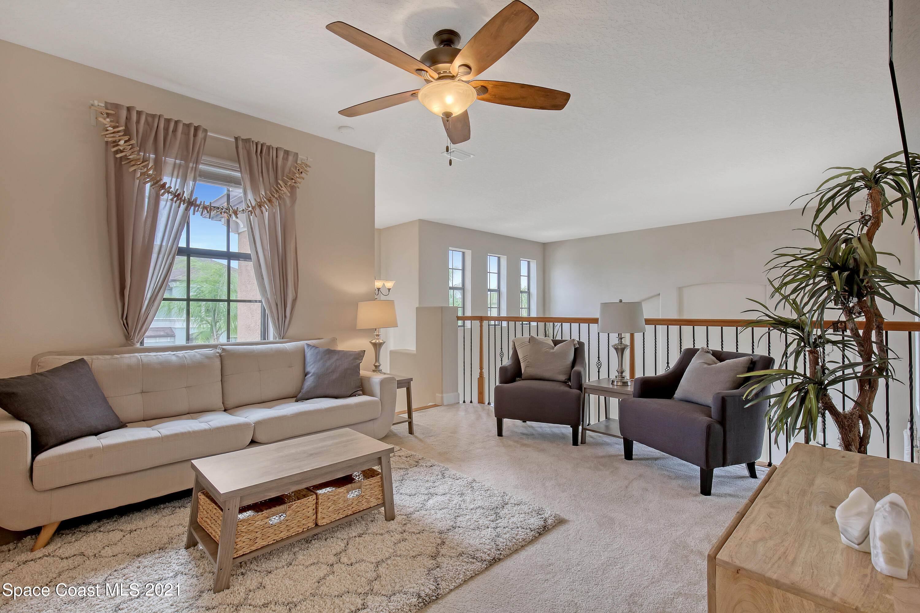 1380 Talon Way Melbourne, FL 32934 - Photo 24 of 59 a living room with furniture and a large window