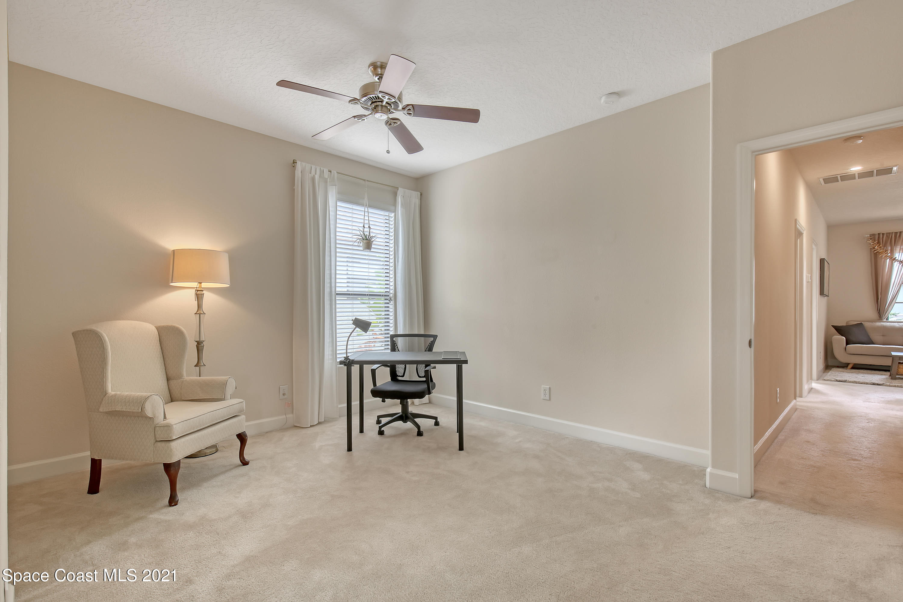 1380 Talon Way Melbourne, FL 32934 - Photo 30 of 59 a view of a livingroom with furniture and a chandelier fan
