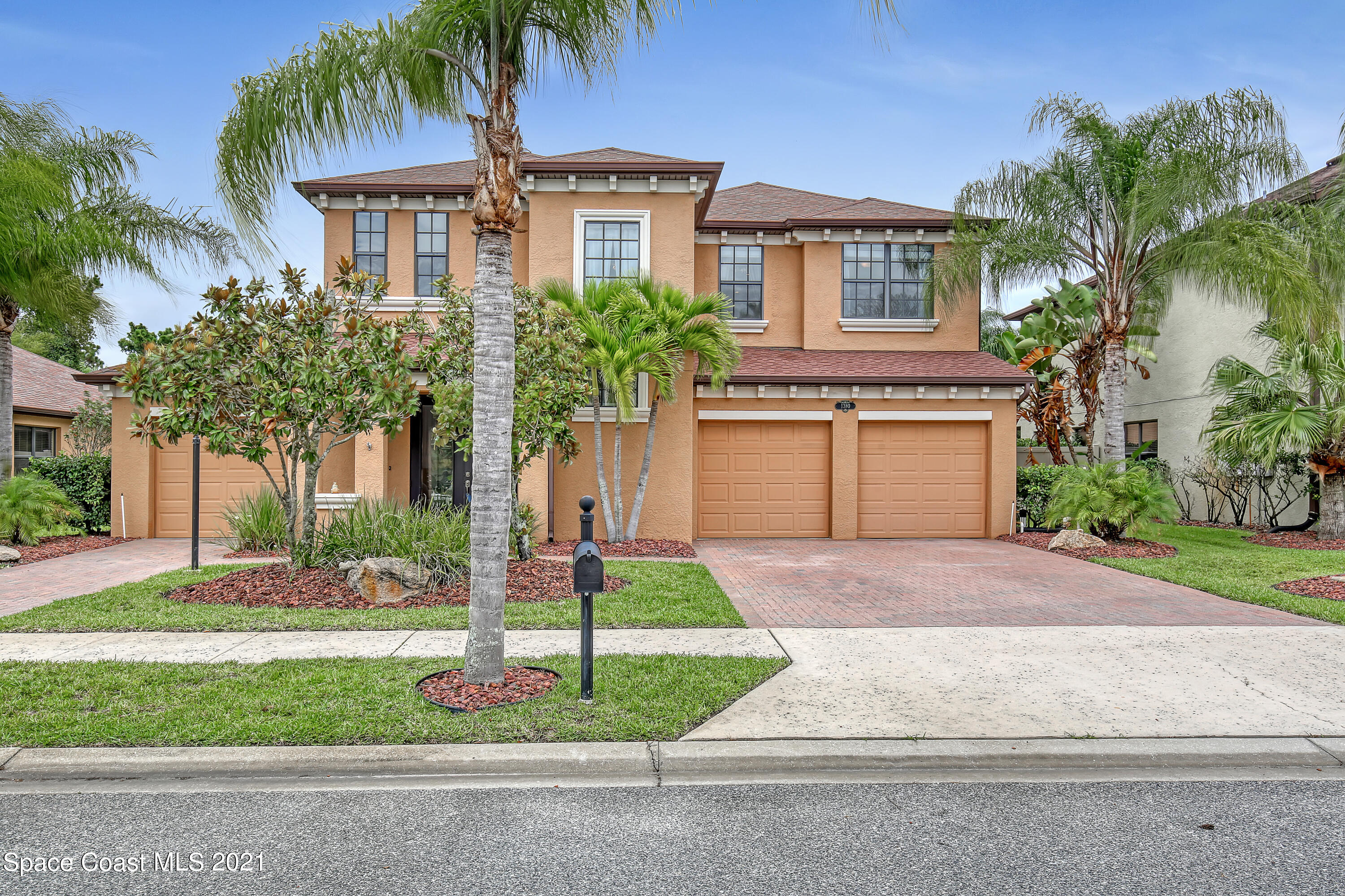 1380 Talon Way Melbourne, FL 32934 - Photo 3 of 59 a front view of a house with a yard and garage