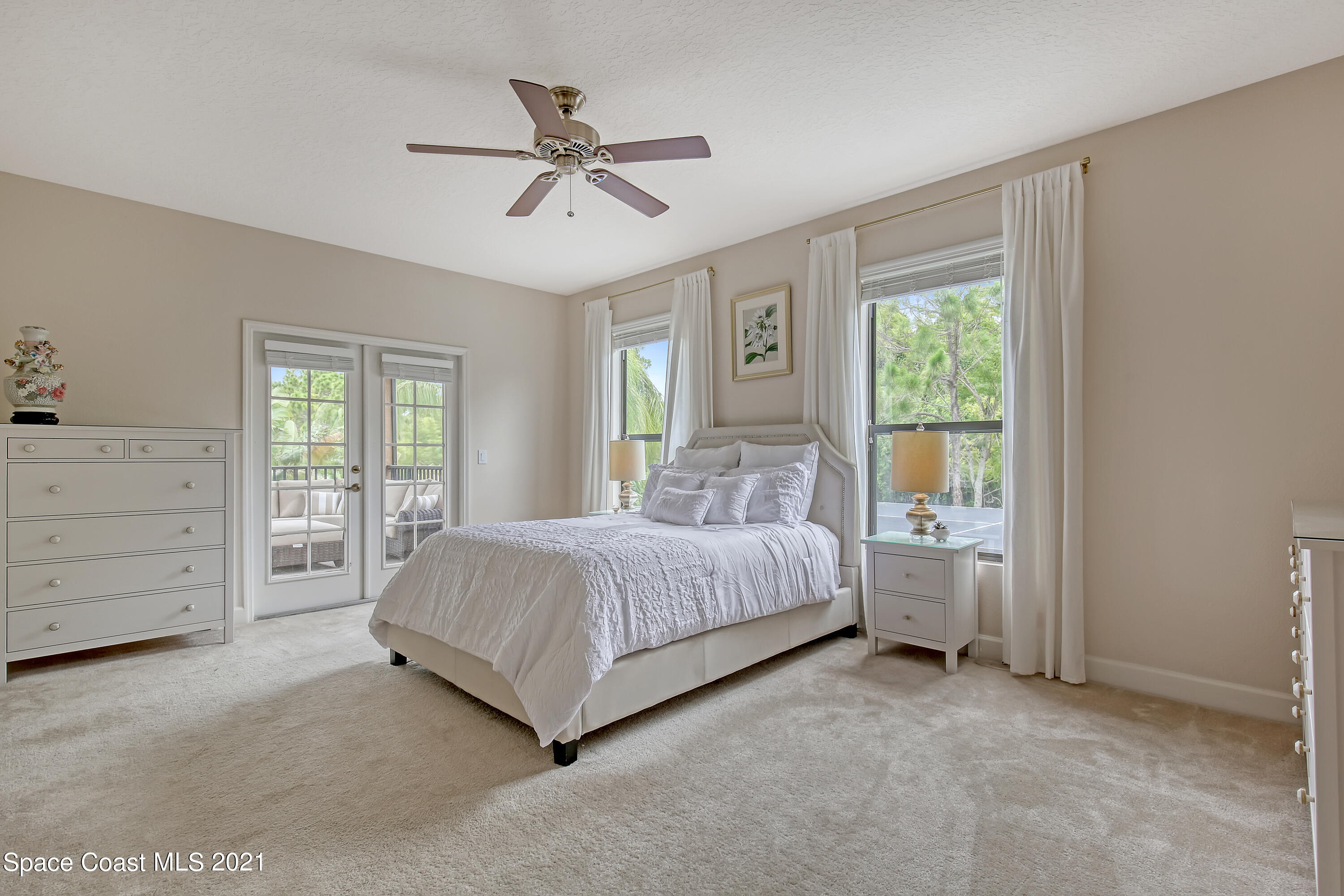 1380 Talon Way Melbourne, FL 32934 - Photo 31 of 59 a spacious bedroom with a bed a dresser and a window