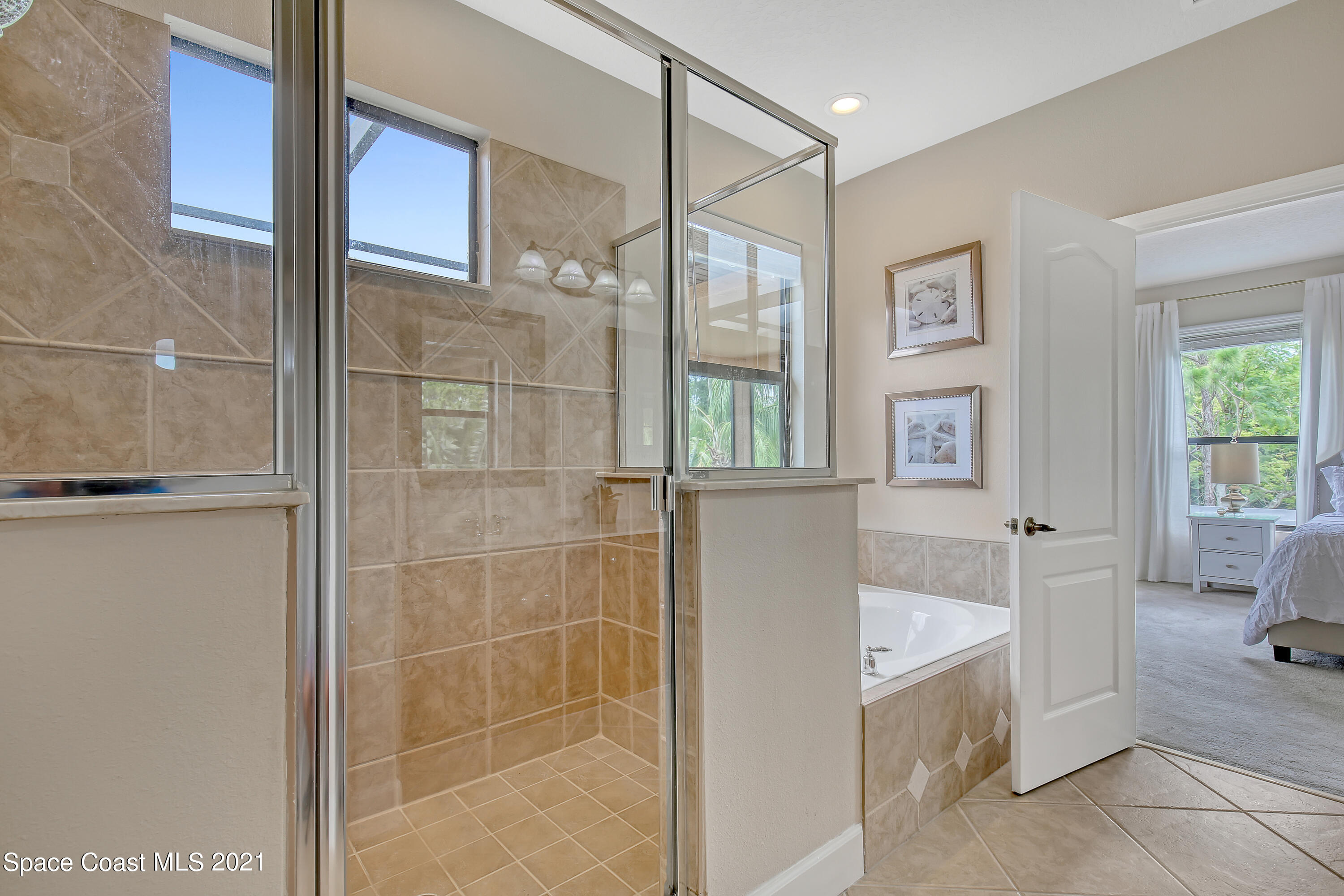 1380 Talon Way Melbourne, FL 32934 - Photo 35 of 59 a bathroom with a tub shower and mirror