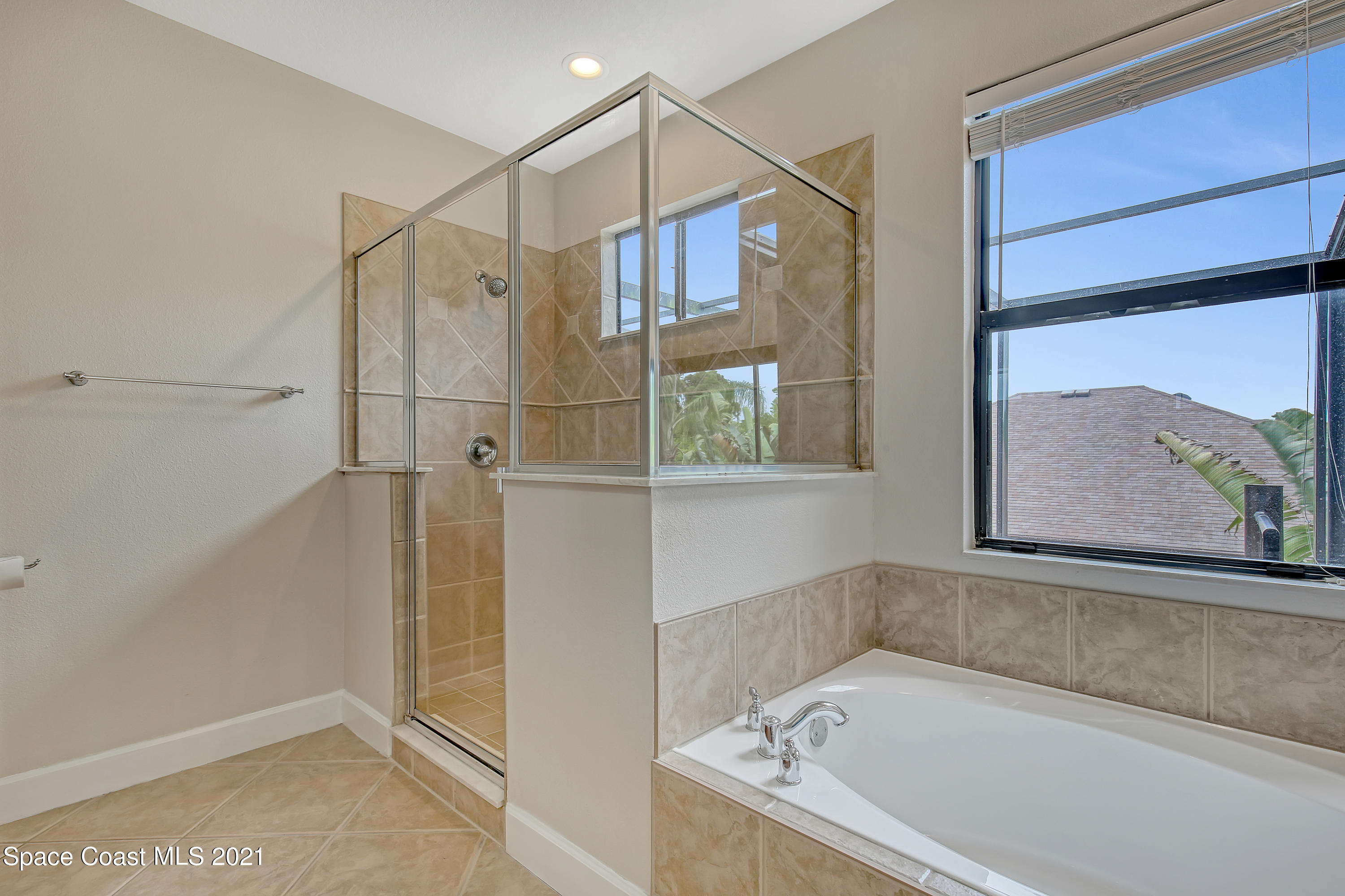 1380 Talon Way Melbourne, FL 32934 - Photo 36 of 59 a bathroom with a tub and a shower