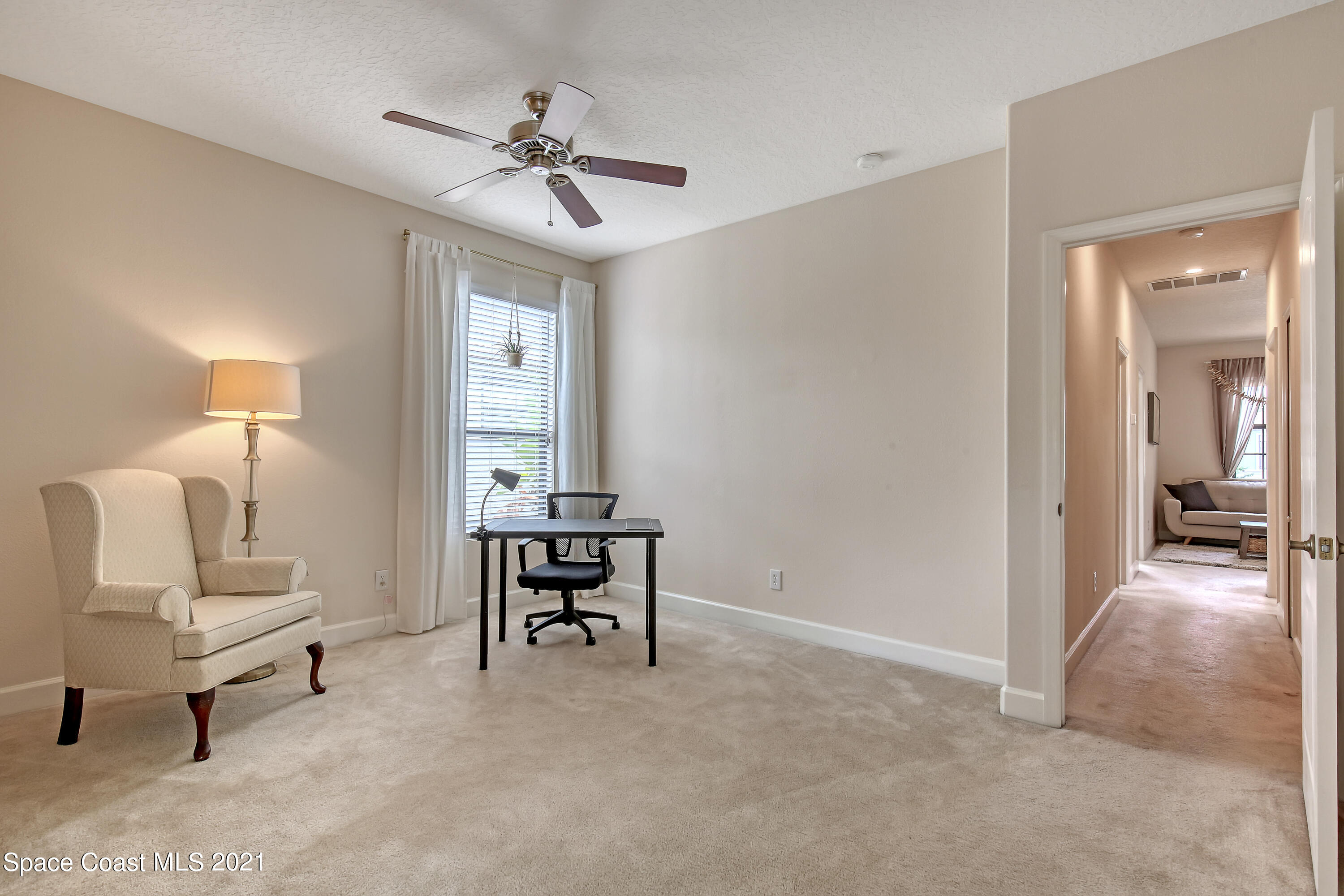 1380 Talon Way Melbourne, FL 32934 - Photo 42 of 59 a view of a livingroom with furniture and a ceiling fan