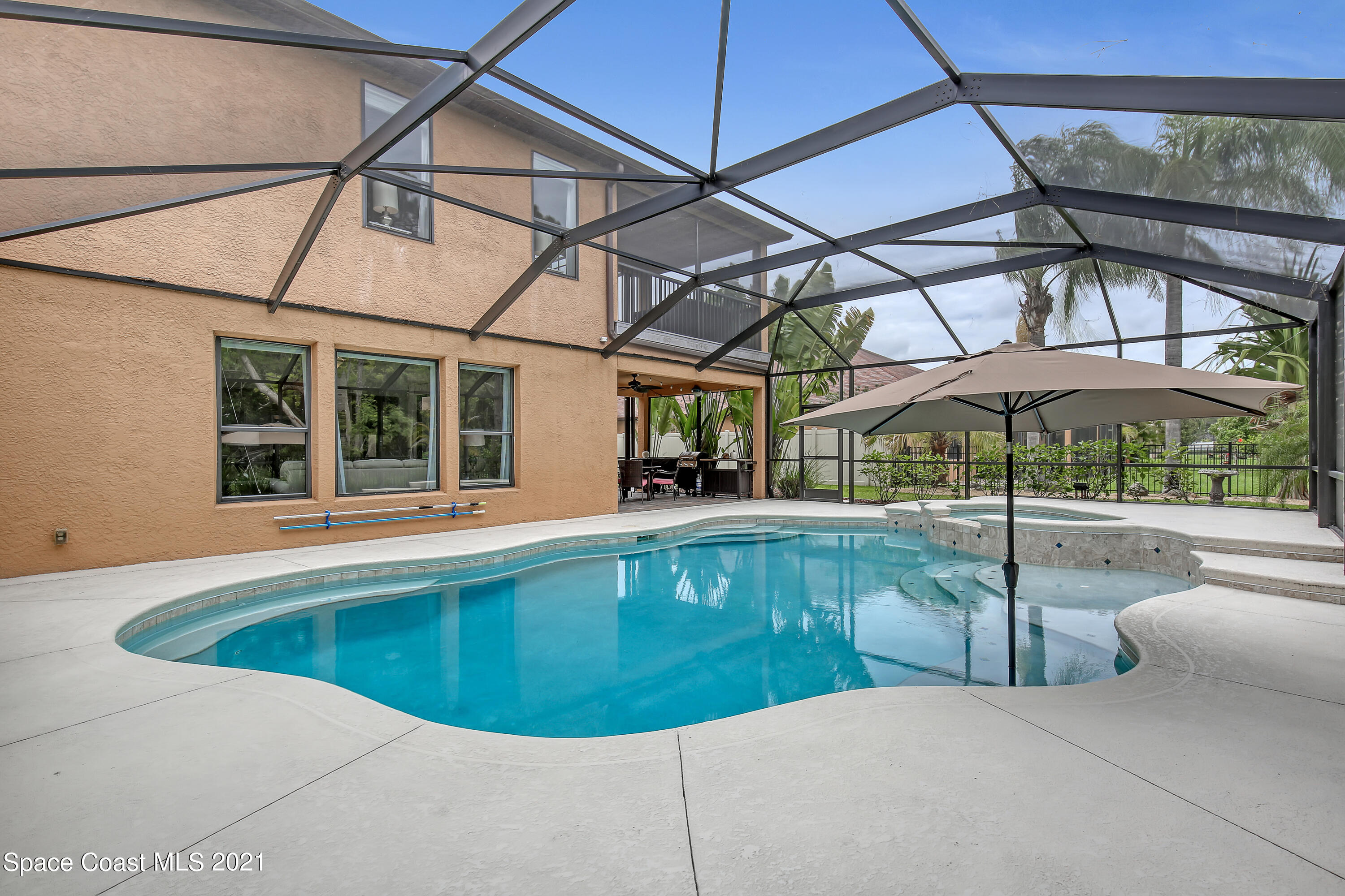 1380 Talon Way Melbourne, FL 32934 - Photo 48 of 59 a view of a swimming pool with a porch