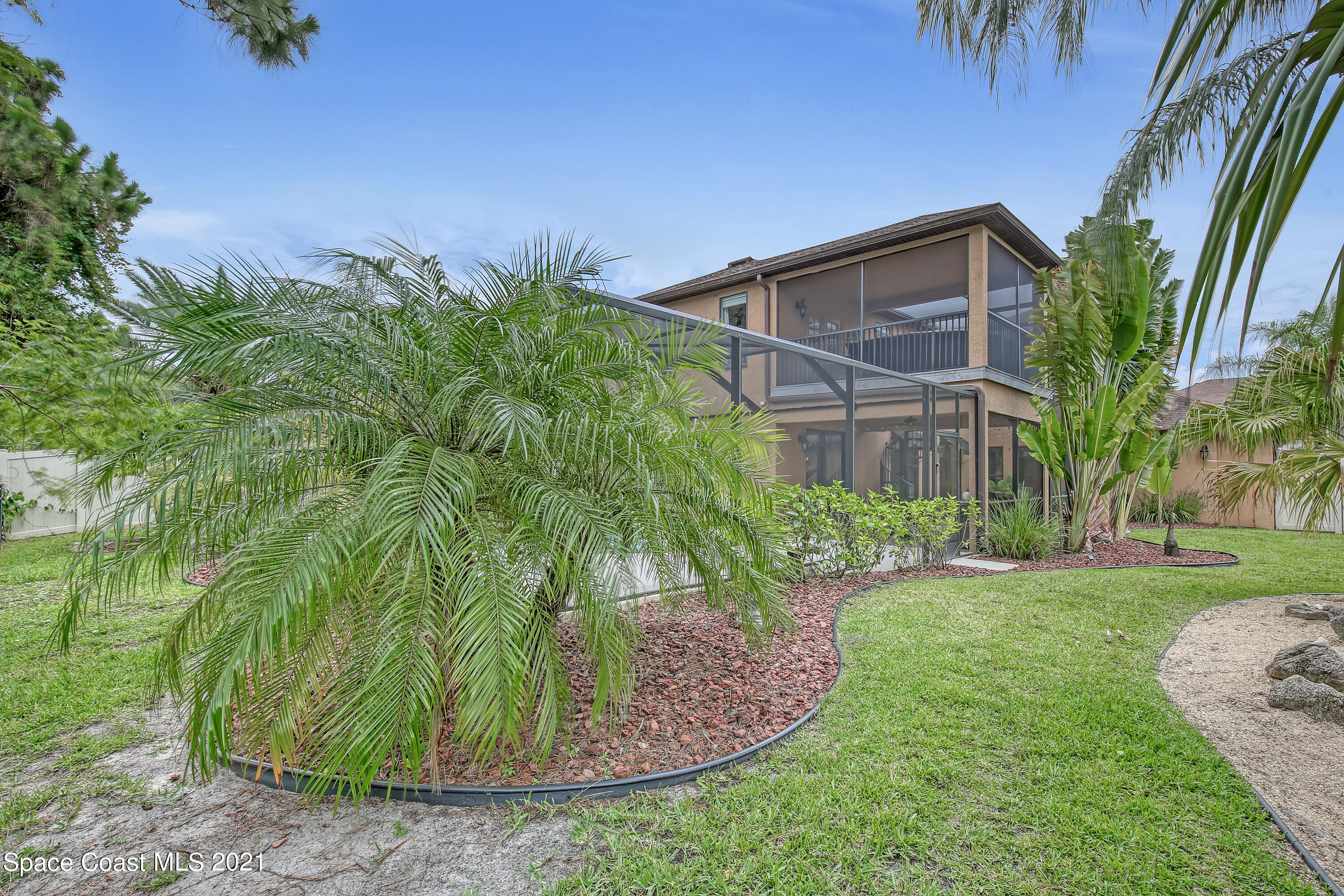 1380 Talon Way Melbourne, FL 32934 - Photo 51 of 59 a view of a backyard that has plants and large trees