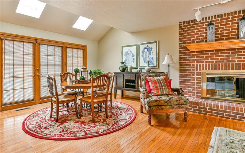 10120 Deer View Point Road Wexford, PA 15090 - Photo 6 of 24 The 28x13 family room is light and bright with two skylights and doors leading onto the deck. Gas log fireplace complements the room. Hardwood floors are continued throughout the family room and into the den.