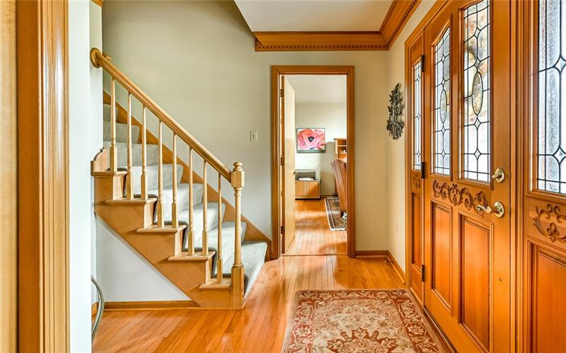 10120 Deer View Point Road Wexford, PA 15090 - Photo 10 of 24 The entry boasts custom wood carved doors. The hardwood floors which are carried throughout the family room, den, living room, and dining room are throughout the 13x12 entry as well.