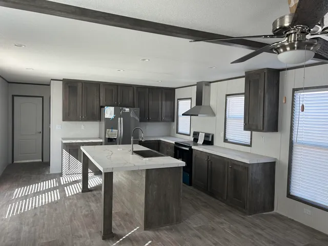 a kitchen with sink cabinets and wooden floor