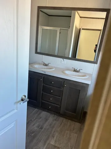 a bathroom with a sink a mirror and a vanity