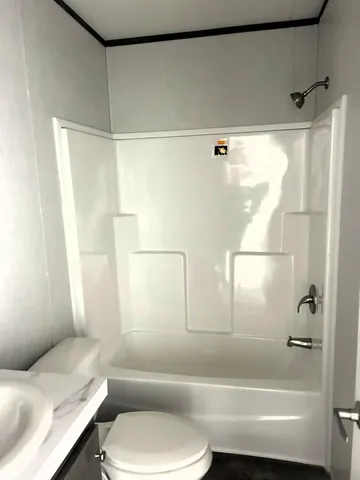 a bathroom with a toilet and a bath tub