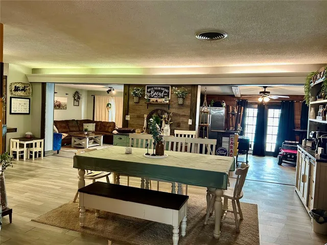 a view of a dining room with furniture and chandelier