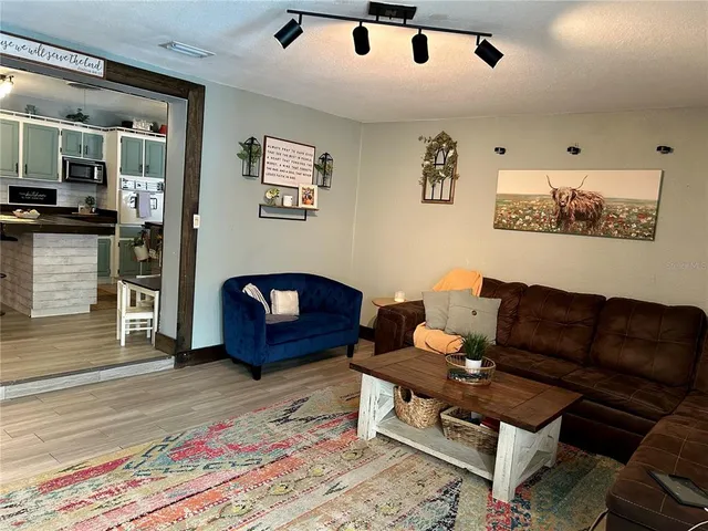 a kitchen with stainless steel appliances granite countertop a stove refrigerator and cabinets