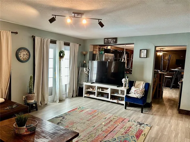 a kitchen with a sink cabinets and wooden floor