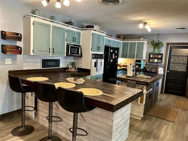 a kitchen view of a appliances and cabinets