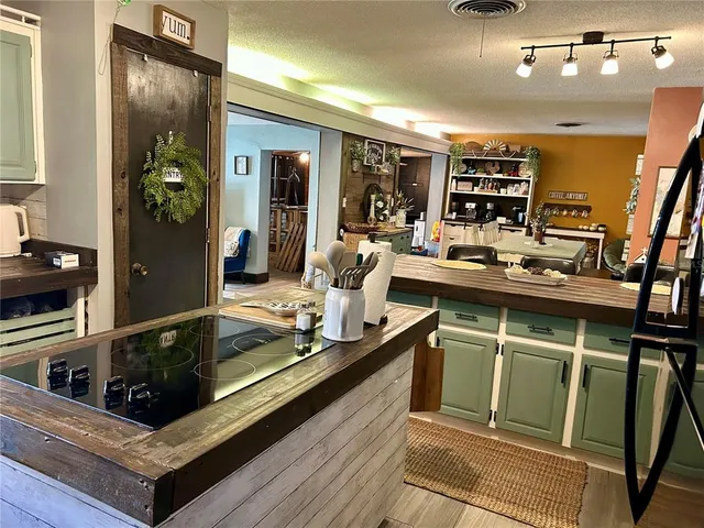 a bed room with a bed mirror and a chandelier