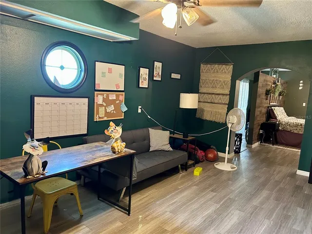 a view of a house with a yard and potted plants