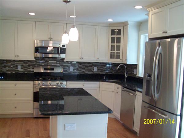 42 Amherst Road Newton, MA 02468 - Photo 4 of 19 a kitchen with stainless steel appliances granite countertop a sink a stove a refrigerator a center island a stove and a refrigerator