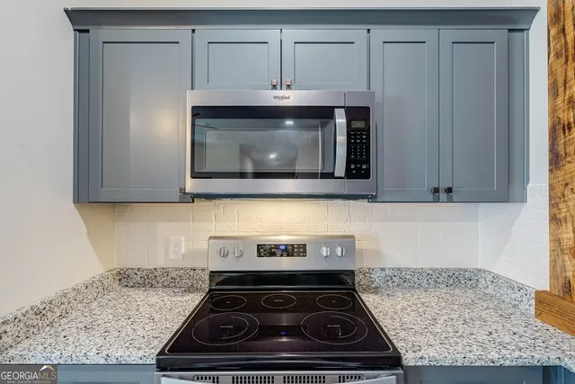 a stove top oven sitting inside of a kitchen