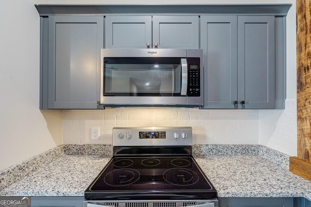 34 Depot Street, Unit 11 Hartwell, GA 30643 - Photo 11 of 21 a stove top oven sitting inside of a kitchen