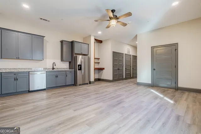 a view of a kitchen with a sink dishwasher refrigerator and a cabinets