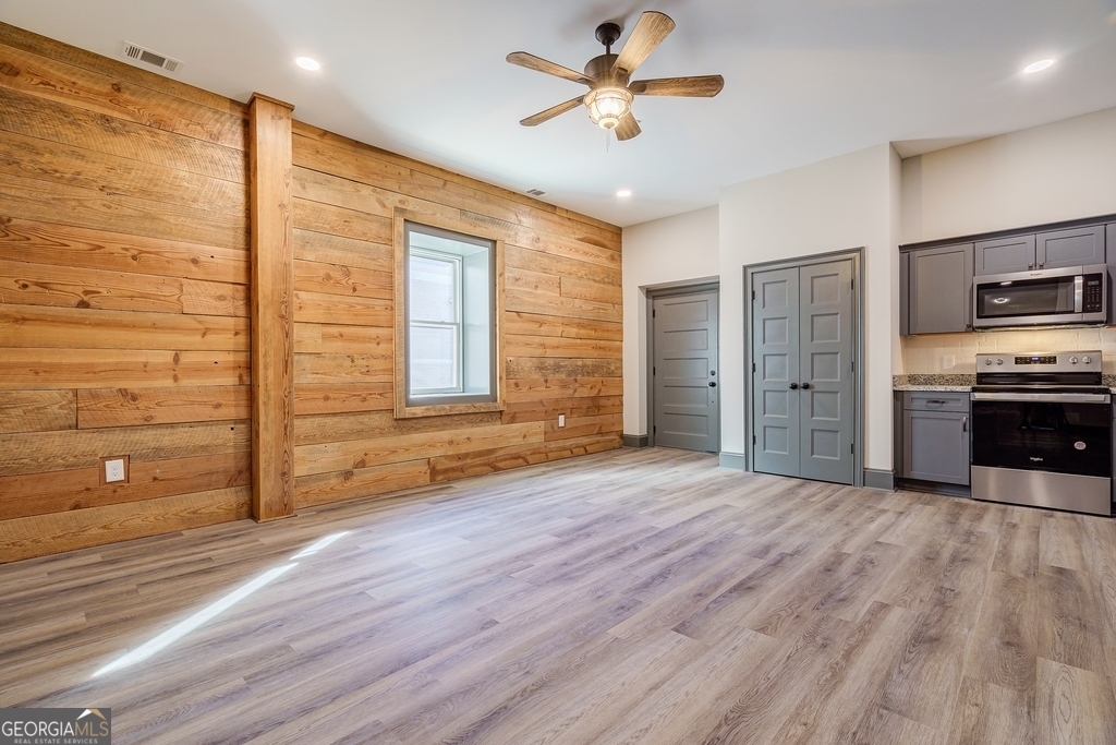 34 Depot Street, Unit 11 Hartwell, GA 30643 - Photo 4 of 21 a view of a livingroom with a hardwood floor and a ceiling fan