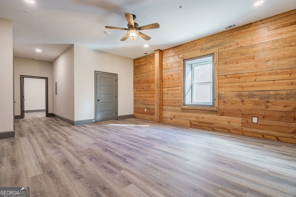 34 Depot Street, Unit 11 Hartwell, GA 30643 - Photo 5 of 21 a view of an empty room with a window and wooden floor