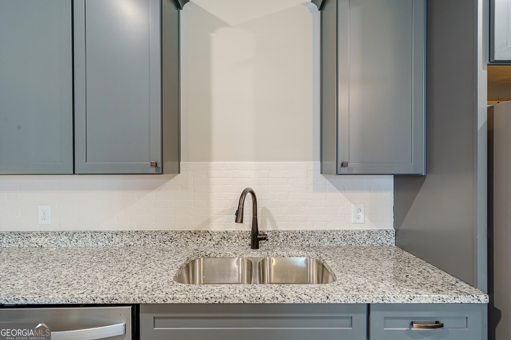 34 Depot Street, Unit 11 Hartwell, GA 30643 - Photo 10 of 21 a kitchen with granite countertop a sink and cabinets