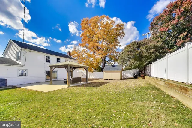 a view of a room with window a ceiling fan and wooden floor