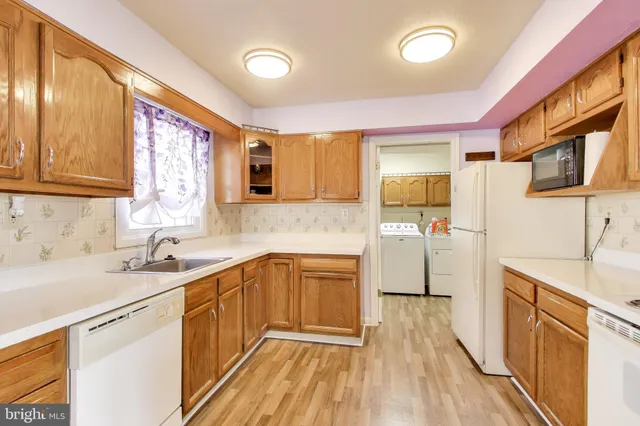 a view of a living room with furniture and wooden floor