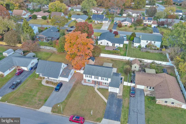 an aerial view of a house with a yard