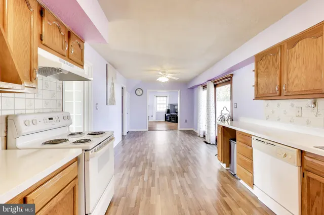 a kitchen with stainless steel appliances a stove sink and cabinets