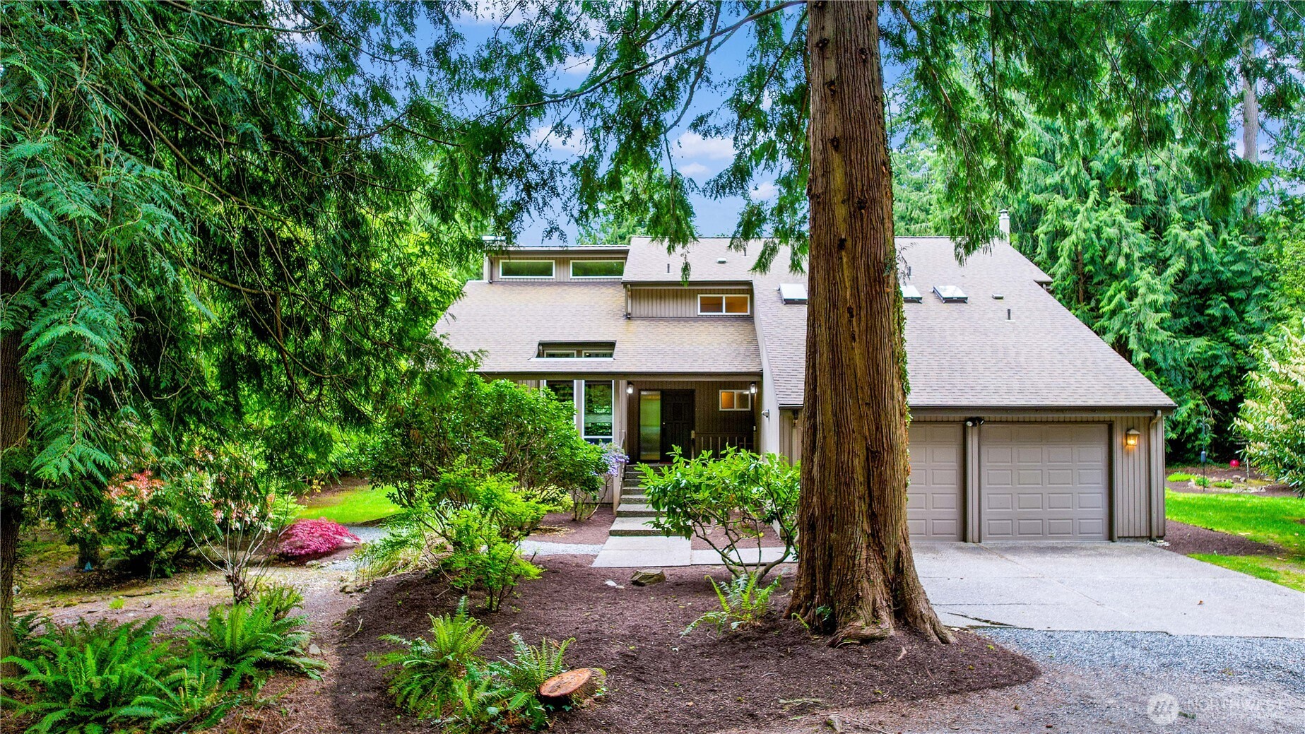 21521 47th Avenue Southeast Bothell, WA 98021 - Photo 1 of 40 a front view of a house with garden