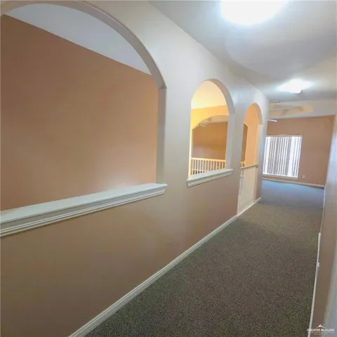 a view of a hallway with windows