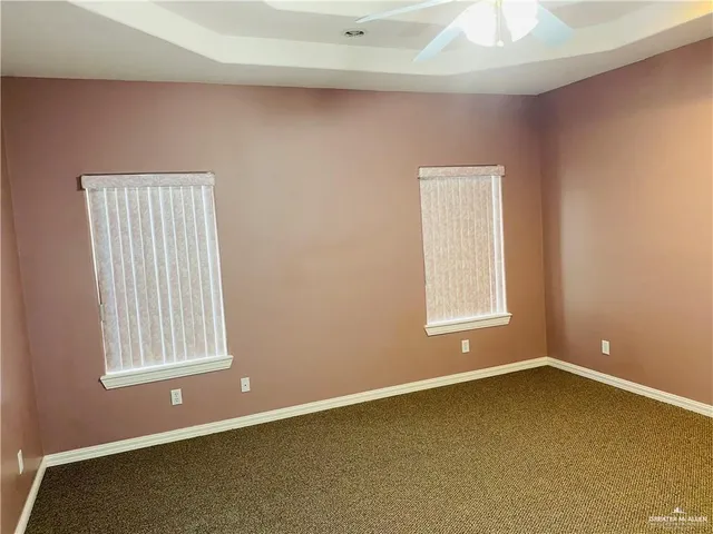 a room with a white cabinets and chandelier