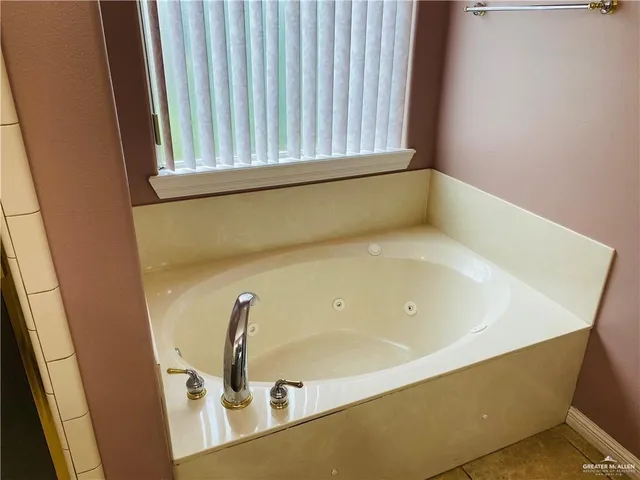 a bathroom with a tub and shower