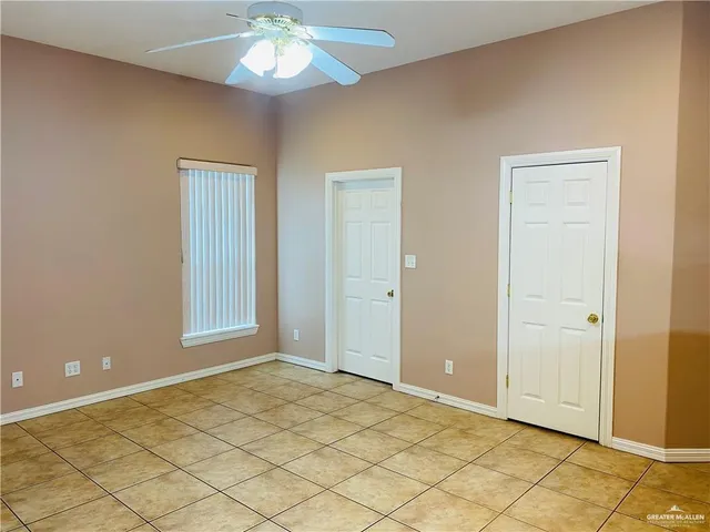 a view of an empty room with a mirror