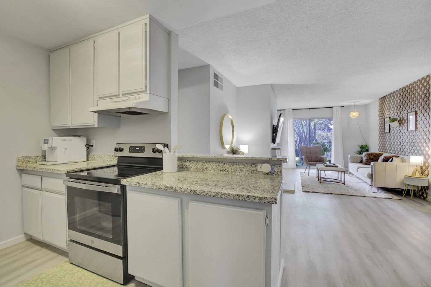 247 North Capitol Avenue, Unit 235 San Jose, CA 95127 - Photo 13 of 30 a kitchen with stainless steel appliances granite countertop a sink stove and cabinets