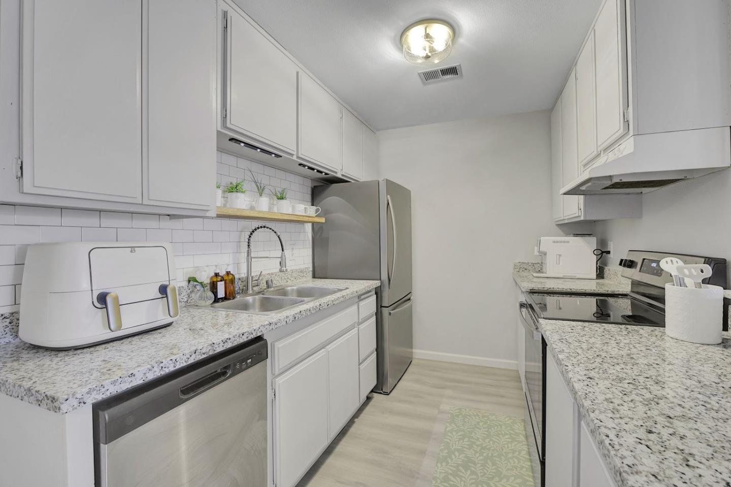 247 North Capitol Avenue, Unit 235 San Jose, CA 95127 - Photo 14 of 30 a kitchen with stainless steel appliances granite countertop a sink stove and cabinets