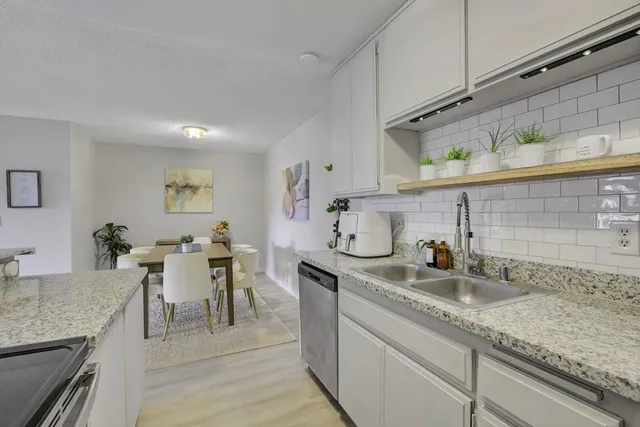 a kitchen with sink cabinets and dining table