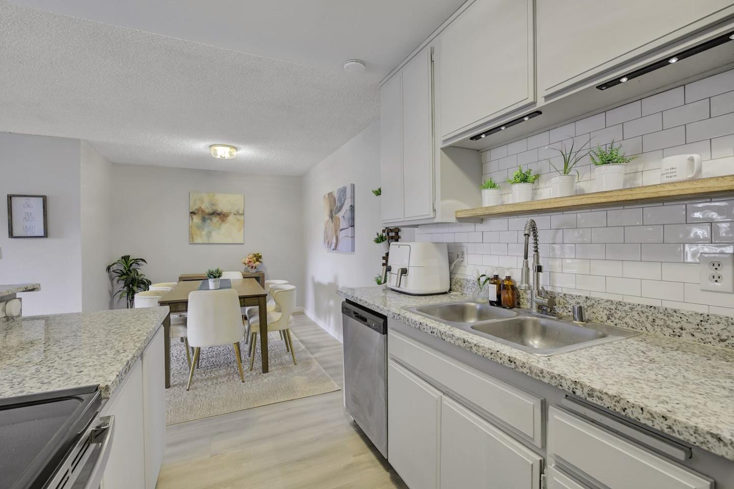 247 North Capitol Avenue, Unit 235 San Jose, CA 95127 - Photo 16 of 30 a kitchen with sink cabinets and dining table