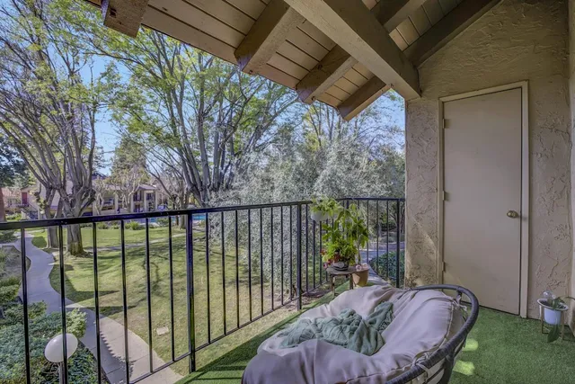 a view of a balcony with furniture