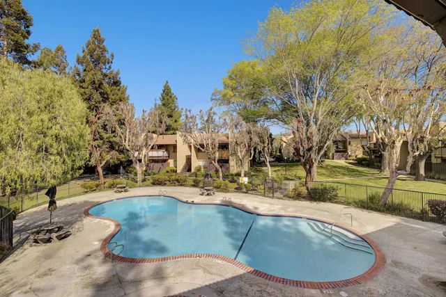 a view of a swimming pool with a patio
