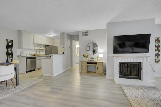 a living room with furniture a fireplace and a flat screen tv