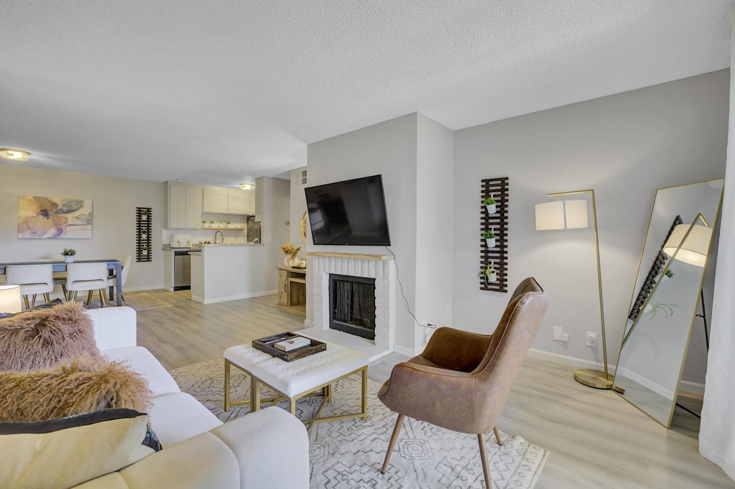 247 North Capitol Avenue, Unit 235 San Jose, CA 95127 - Photo 7 of 30 a living room with furniture a fireplace and a flat screen tv