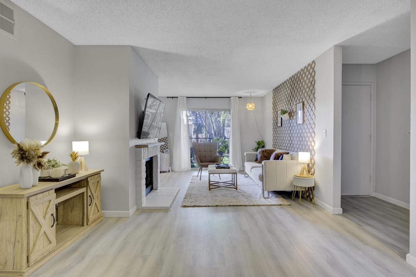 247 North Capitol Avenue, Unit 235 San Jose, CA 95127 - Photo 9 of 30 a living room with furniture a fireplace and a flat screen tv
