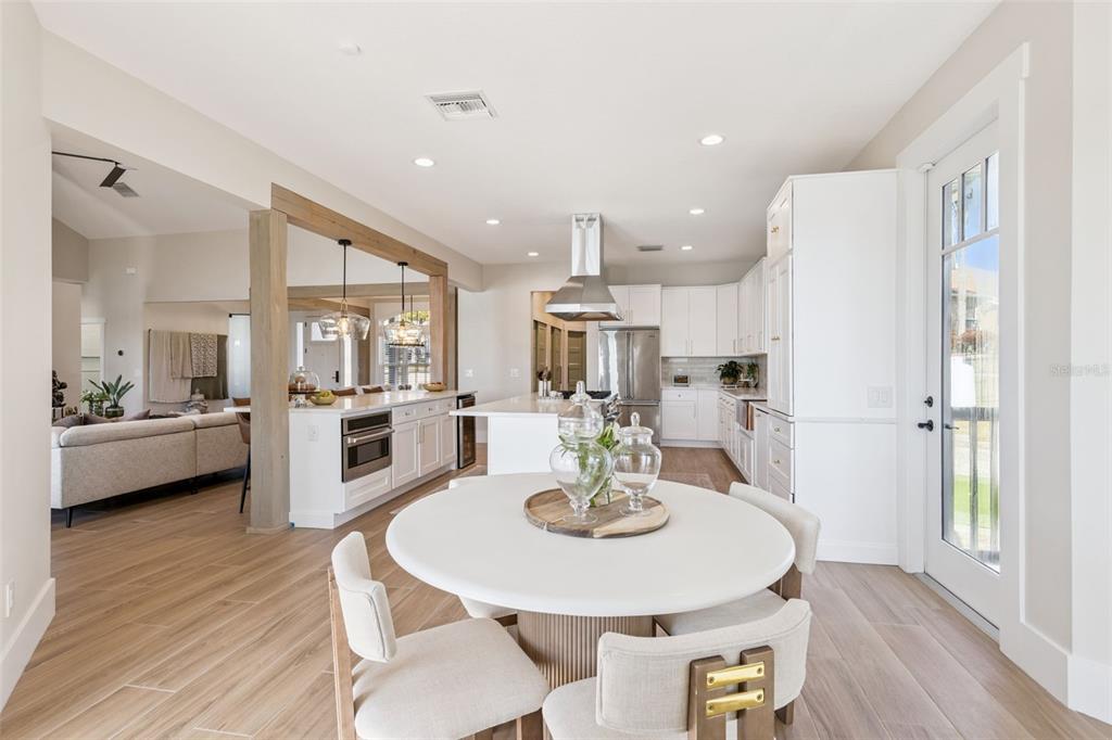 9126 Lake Coventry Court Gotha, FL 34734 - Photo 18 of 75 a kitchen with a dining table chairs and white cabinets