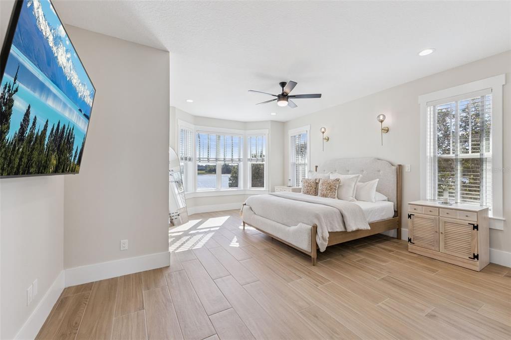 9126 Lake Coventry Court Gotha, FL 34734 - Photo 20 of 75 a spacious bedroom with a large bed and a window