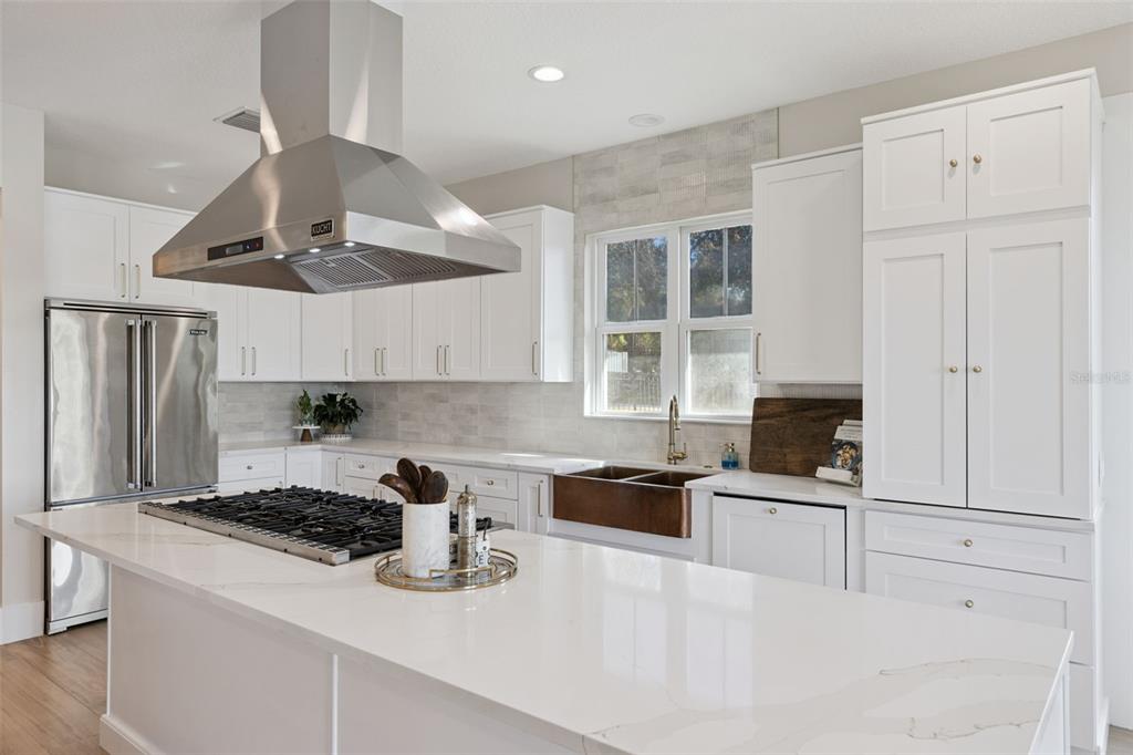 9126 Lake Coventry Court Gotha, FL 34734 - Photo 21 of 99 a kitchen with stainless steel appliances granite countertop a sink stove and refrigerator