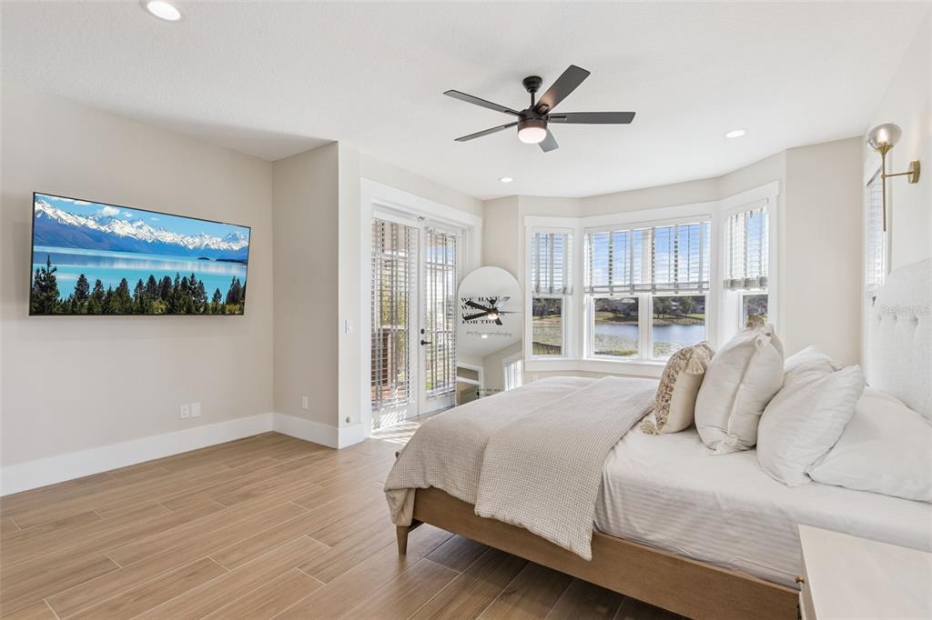 9126 Lake Coventry Court Gotha, FL 34734 - Photo 22 of 75 a bedroom with a large bed window and a painting